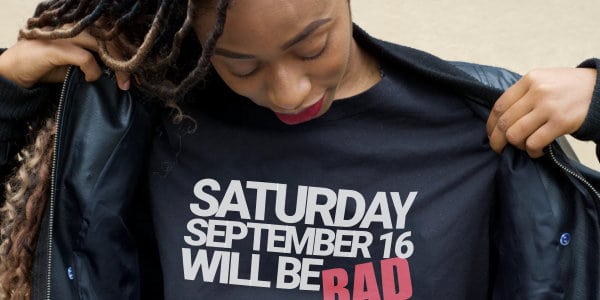 A Bad Day Woman taking off coat with t-shirt stating: Saturday September 16 Will Be BAD