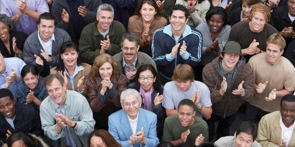 Diverse group of people looking into the lens; captured slightly from above