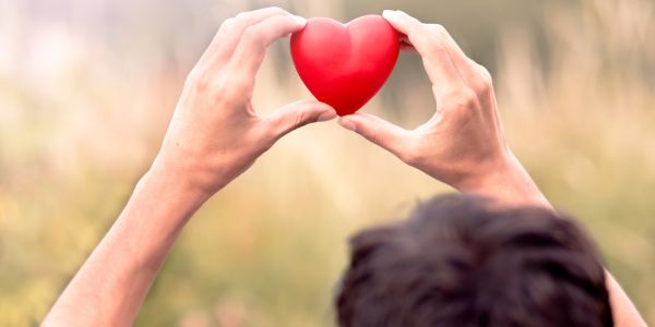 Man holding a red heart