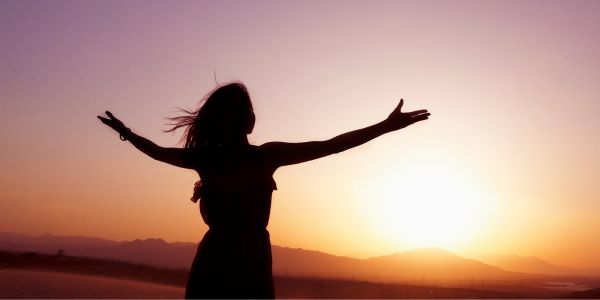 Woman celebrating the sunset