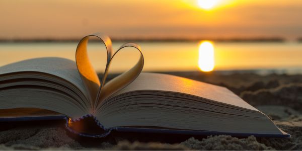 Open book, with two pages rolled into a heart shape - signifying "love"