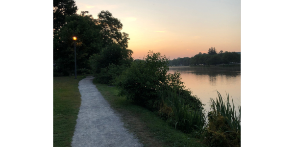 Morning Run: a path in a park alongside a river, at dawn